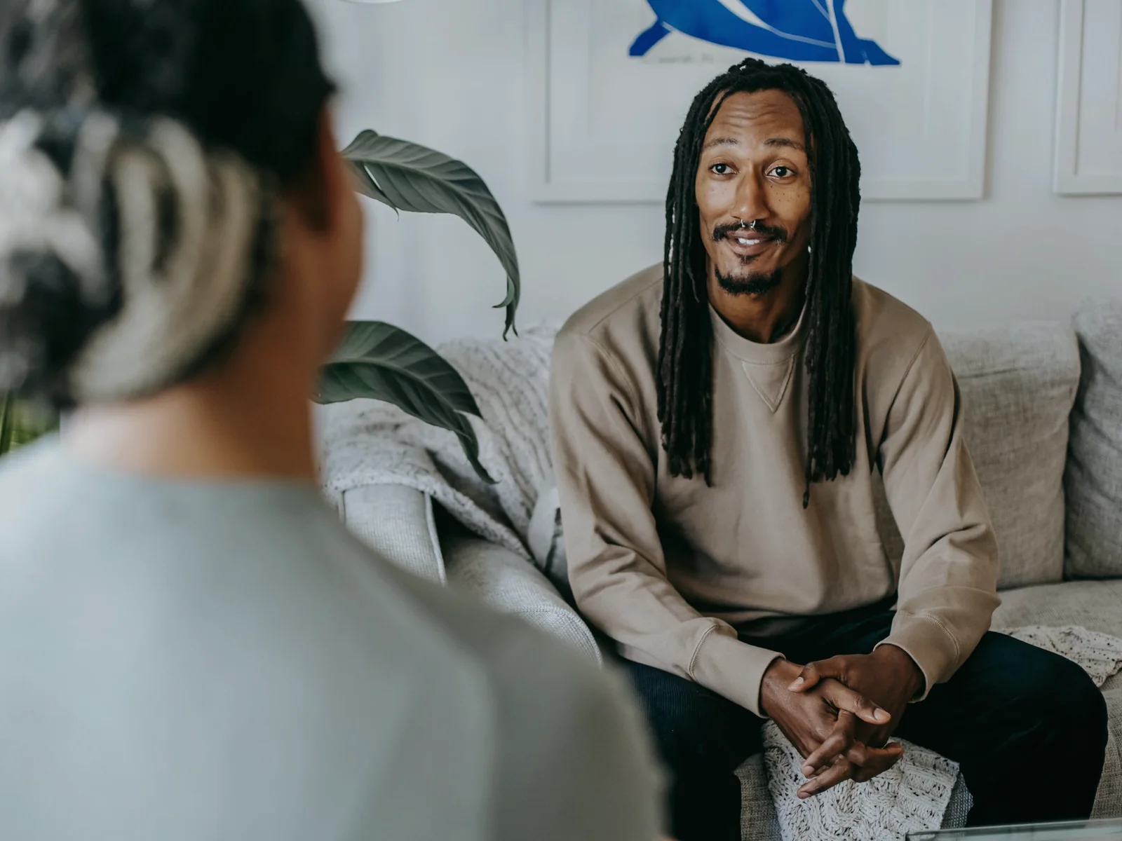 Two adults having a calm conversation in a living room