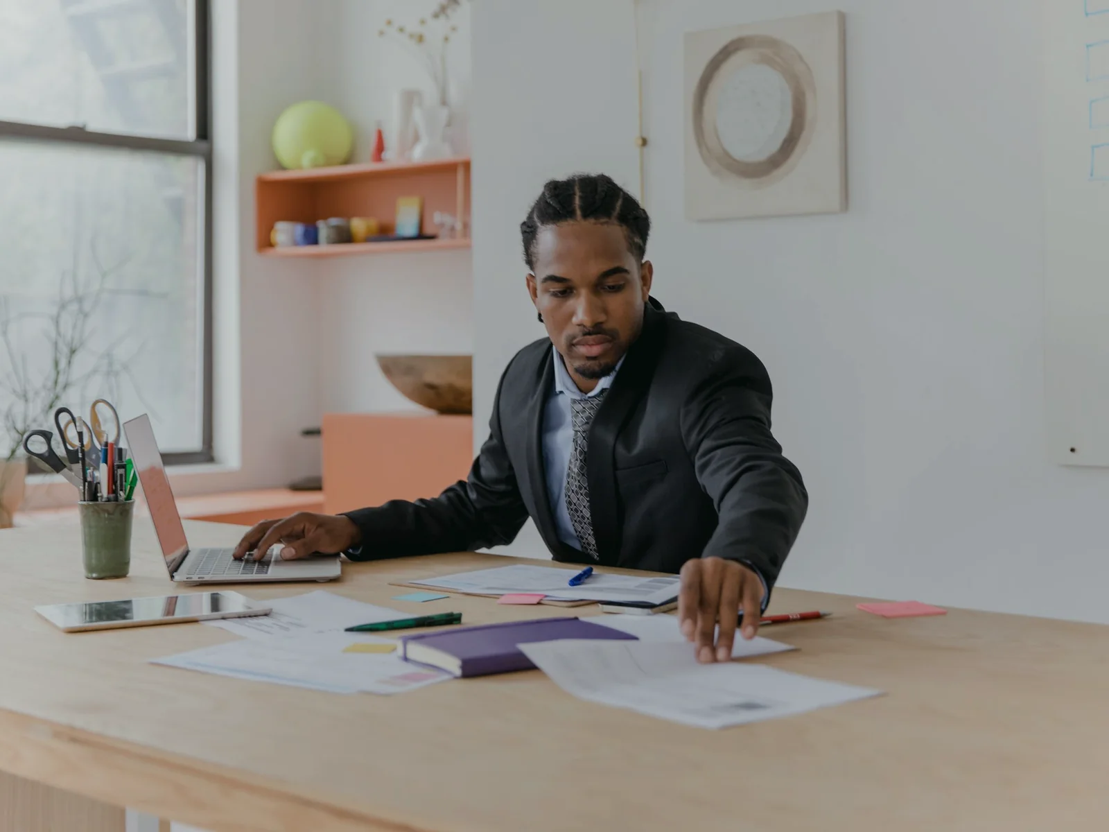 Adult organizing papers at a spacious work desk