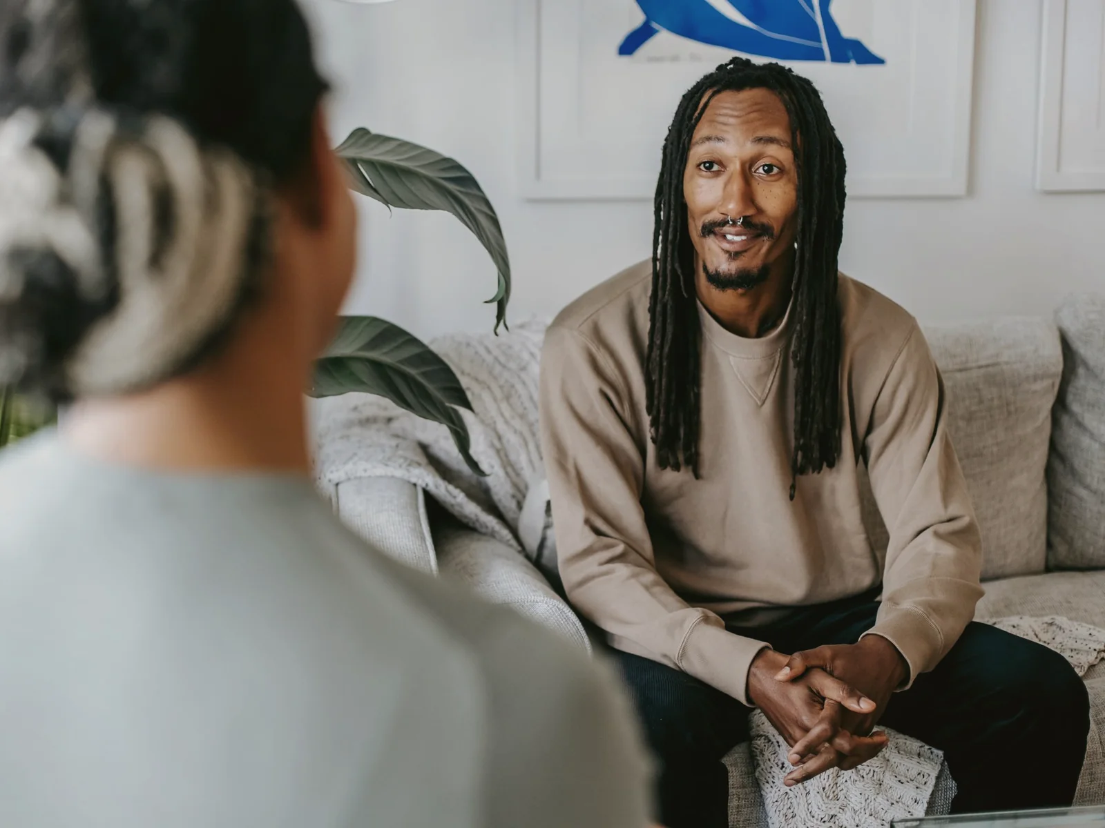 Two adults seated in a private conversation at home